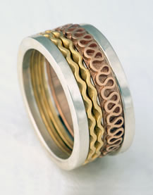 'Stacking Ring' with square outer bands and centre waves in mixed metals